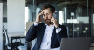 concerned-male-entrepreneur-talking-cellphone-touching-head-stress-having-unpleasant-mobile-call